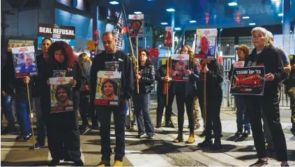  ?? (Carlos Garcia Rawlins/Reuters) ?? FRIENDS, FAMILY members and supporters of hostages kidnapped on October 7 call for their release, during a rally outside the Defense Ministry in Tel Aviv yesterday.