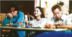  ??  ?? Linus Chung (left), Sharifah Amani and Choo Seong Ng onscreen in one of the many awkward situations in the late director Yasmin Ahmad’s moving drama-comedy Sepet (2005).