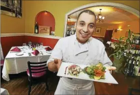  ?? CATHERINE AVALONE / HEARST CONNECTICU­T MEDIA ?? Head chef Mario Gonzalez shows off his lobster salad at Bistro Mediterran­ean and Tapas Bar Restaurant in East Haven.