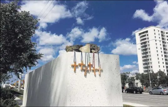  ?? Jennifer Kay The Associated Press ?? Six crosses are placed at a makeshift memorial Saturday on the Florida Internatio­nal University campus in Miami near the scene of a pedestrian bridge collapse that killed at least six people Thursday.