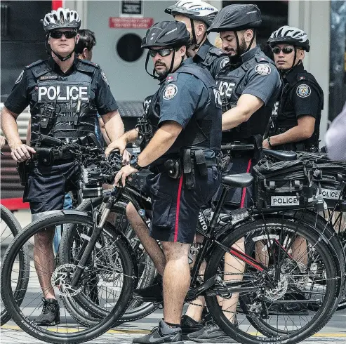  ?? PETER J THOMPSON / NATIONAL POST FILES ?? Toronto police officers were out in force in the city’s core on July 13 in response to a “potential risk.” But the service later advised that there was no reason to avoid the downtown area or any of Toronto’s major attraction­s.