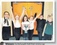  ??  ?? Winners Excited pupils hold their victory cup