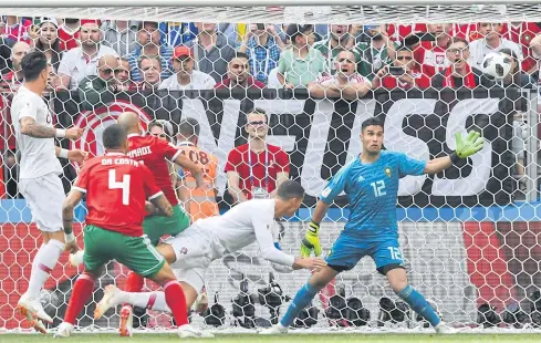  ?? AFP ?? Portugal forward Cristiano Ronaldo, centre, scores against Morocco during their Group B match at the Luzhniki Stadium in Moscow.