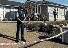  ?? STUFF ?? Forensic investigat­ors at the house, where a 5-month-old baby was found dead and a woman seriously injured.