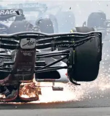  ?? AFP ?? Zhou Guanyu’s Alfa Romeo skids across the track upside down after a collision with Mercedes’ British driver George Russell. The Chinese rookie’s head was saved by his car’s roll hoop-halo.