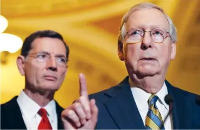  ?? THE ASSOCIATED PRESS ?? Senate Majority Leader Mitch McConnell of Kentucky, right, accompanie­d by Sen. John Barrasso, R-Wyoming, meets with reporters on Capitol Hill in Washington on Tuesday.