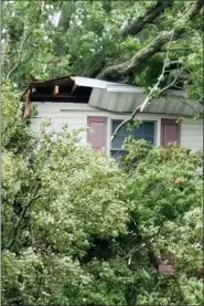  ?? JAMES BURKE VIA AP ?? Damage to a Garden City, N.Y., home caused by an uprooted tree during Tropical Storm Isias in 2020.