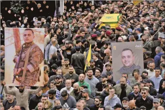  ?? AP photo ?? Hezbollah fighters carry the coffin of their comrade, Ali Ahmad Hussein, who was killed by an Israeli strike in south Lebanon, during his funeral procession in the southern Beirut suburb of Dahiyeh, Lebanon on Monday. Israel’s military says it has killed a commander of Hezbollah’s secretive Radwan Force in southern Lebanon.