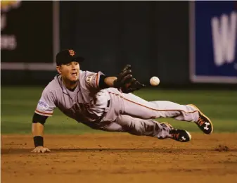  ?? Charlie Neibergall / Associated Press 2014 ?? Second baseman Joe Panik flips the ball to shortstop Brandon Crawford to start a third-inning double play during the Giants’ Game 7 victory over the Royals in the 2014 World Series.