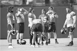  ?? JOHN RAOUX/AP ?? Jaguars quarterbac­k Gardner Minshew II (15) talks with teammates during a preseason workout. Jaguars general manager Dave Caldwell said he believes the team can win this season despite trading away some of its biggest stars.