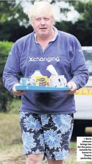  ??  ?? &gt; Boris Johnson brings tea for the press outside his house in Thame yesterday