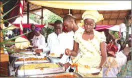  ??  ?? Guests getting food at a wedding