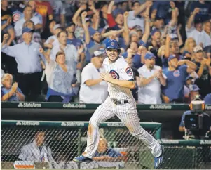  ?? "1 1)050 ?? In this July 2016 file photo, Chicago Cubs’ Kris Bryant scores on a single during the eighth inning of a game against the Atlanta Braves in Chicago.