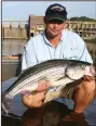  ?? (Arkansas Democrat-Gazette/ Bryan Hendricks) ?? You can catch striped bass in shallow water from February through June in many of our big reservoirs but also in overlooked areas like the Ouachita River below Remmel Dam.