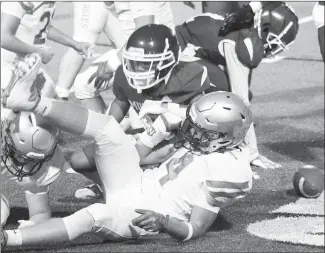  ?? Fred Conley • Times-Herald ?? Forrest City and Greene County Tech players scramble to find the loose football after a fumble during Friday's Hall of Fame Game played at Sam Smith Stadium. Greene County Tech won the game 42-8, dropping the Mustangs to 1-3 for the year. Forrest City avoided the shutout late in the game when Darius Cross scored and added the two- point play. Forrest City will be on the road Friday night at Valley View.