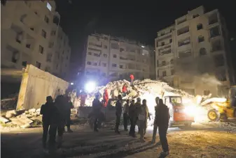  ?? Omar Haj Kadour / AFP / Getty Images ?? Emergency crews search for survivors in the rubble of a six-story building that collapsed Sunday following Syrian government air strikes against rebel positions in Idlib province.