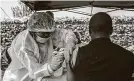  ?? Pamela Tulizo / AFP/Getty Images ?? A man receives a vaccine against Ebola from a nurse in July 2019 in Goma, Democratic Republic of Congo.