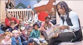  ?? Contribute­d ?? Dr. Pamela Obi, director of quality improvemen­t at Atrium Health Floyd Medical Center Family Medicine Residency, reads her book “Moo and Bark” to children at the Rome Floyd County Library’s auditorium. This is her first book.