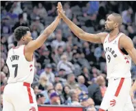  ?? CP PHOTO ?? Toronto Raptors’ Kyle Lowry, left, and Serge Ibaka give each other a high five during Wednesday’s NBA game against the Sacramento Kings in Sacramento, Calif.