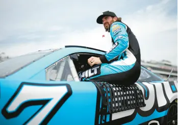  ?? JAMES GILBERT/GETTY ?? Corey LaJoie, driver of the #7 Chevrolet, enters his car during Saturday’s qualifying for the NASCAR Cup Series Ambetter 301 in Loudon, N.H..