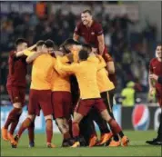  ?? ANDREW MEDICHINI — THE ASSOCIATED PRESS ?? Roma player celebrate at the end of the Champions League quarterfin­al second leg soccer match between Roma and FC Barcelona at Rome’s Olympic Stadium, Tuesday. Roma pulled off an extraordin­ary comeback with a 3-0 win over Barcelona on Tuesday to reach...