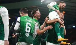  ?? ?? Ryan Porteous lifts Martin Boyle on his shoulders after the attacker’s hat-trick sealed a spot in the cup final for Hibs