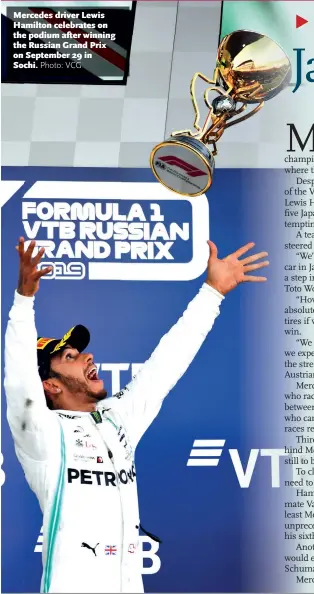  ?? Photo: VCG ?? Mercedes driver Lewis Hamilton celebrates on the podium after winning the Russian Grand Prix on September 29 in Sochi.
