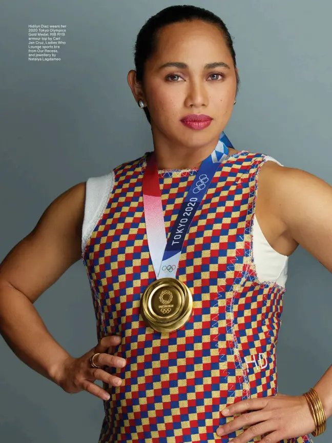  ??  ?? Hidilyn Diaz wears her 2020 Tokyo Olympics Gold Medal. RIB RYB armour top by Carl Jan Cruz, Ladies Who Lounge sports bra from Our Recess, and jewellery by Natalya Lagdameo