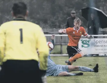  ??  ?? Brighouse Town’s Isaac Baldwin looks to home in on goal against Scarboroug­h