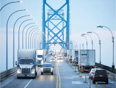  ?? COLE BURSTON/BLOOMBERG ?? Commercial trucks and passenger vehicles drive across the Ambassador Bridge in Windsor, Ont. A National Associatio­n for Business Economics survey found that 91 per cent of respondent­s believe U.S. threats of additional tariffs were affecting the economy negatively.