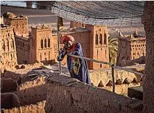  ?? Getty Images ?? A man stands atop the ancient fortress of Ait-ben-Haddou, where scenes depicting the fictional city of Yunkai from ‘Game of Thrones’ were filmed.