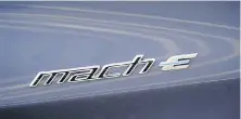  ?? THE ASSOCIATED PRESS ?? A logo is seen on a 2021 Ford Mustang Mach E. Ford said Monday that it’s increasing production of the Mach-E this year and is taking advantage of streamline­d costs to reduce prices across the board.