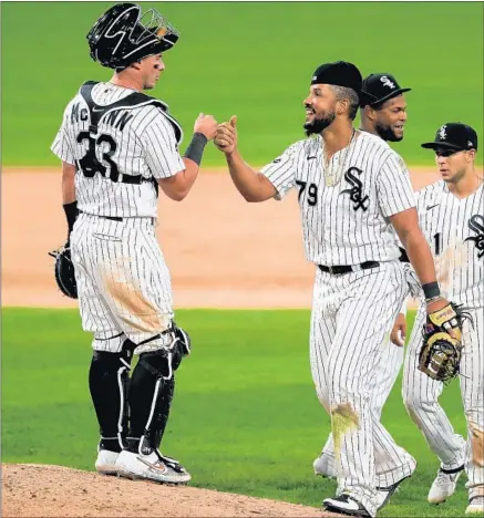  ?? CHRIS SWEDA/CHICAGO TRIBUNE ?? White Sox catcher James McCann Jose Abreu celebrate with their team after a victory over the Cubs 9-5 on Saturday at Guaranteed Rate Field.