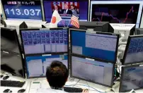  ?? AFP ?? US President Donald Trump is seen on a TV monitor while delivering his first speech to Congress at a foreign exchange brokerage in Tokyo on Wednesday. —