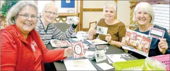  ?? Keith Bryant/The Weekly Vista ?? Deb Dakken (left) shows off a card she’s made, alongside Carrie Hamilton, Charla Everhart and Jane Para during a cardmaking class at the Wishing Spring Gallery last Friday. Para hosts a cardmaking class on the second Friday of each month, from 3 to 5 p.m. Materials are included at $5 per card and attendees may make up to three cards.