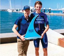  ?? — AFP photo ?? Pithie (right) poses with Evans and the trophy for winning the 2024 Men’s Elite Cadel Evans Great Ocean Road Race in Geelong.