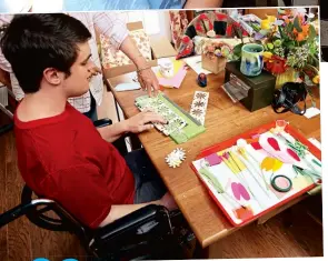  ??  ?? “Crafting flowers gave Andrew [ left] a sense of accomplish­ment and purpose— and shows other people with autism and their families all the beautiful and brilliant things they are capable of doing,” says Cate