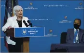  ??  ?? President-elect Joe Biden, right, listens as Janet Yellen, who Biden nominated to serve as Secretary of the Treasury, speaks at The Queen theater, Tuesday in Wilmington, Del.