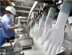  ?? — Reuters photo ?? Earnings growth in the rubber gloves sector are expected to slow down but remain resilient as the demand-supply dynamics in the industry normalises.
