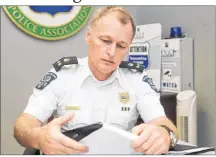  ?? MITCH MACDONALD/THE GUARDIAN ?? Deputy Police Chief Brad MacConnell makes some notes at the Charlottet­own police station on Monday shortly after the department announced it had charged a 39-year-old city woman with two counts of infanticid­e. The charges, which followed more than a...