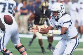  ?? Edward Diller / Getty Images ?? UConn QB Tyler Phommachan­h has been getting plenty of support and advice from his older brother Taisun, a QB at Clemson.