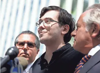  ?? ASSOCIATED PRESS ?? Martin Shkreli (center), with his attorneys, talks to reporters Friday in front of federal court in New York. The former pharmaceut­ical CEO was convicted on federal charges he deceived investors in a pair of hedge funds.