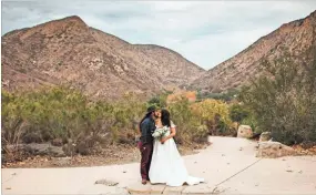  ?? AP-Kristen Pritchard Photograph­y ?? Kayleigh and Cody Cousins pose for wedding photos at Mission Trails Regional Park in San Diego, Calif., on Dec. 27, 2020. They initially planned an April 2020 wedding, postponed it after the pandemic took hold, reschedule­d it for December, then had to shift gears again when a new lockdown was imposed. “That was devastatin­g,” said Kayleigh. “We said, ‘Let’s just do it on Zoom.’”