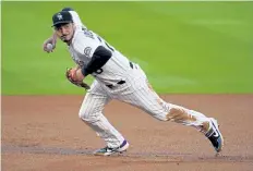  ?? David Zalubowski, The Associated Press ?? Rockies third baseman Nolan Arenado has won eight Gold Gloves wearing purple and white.