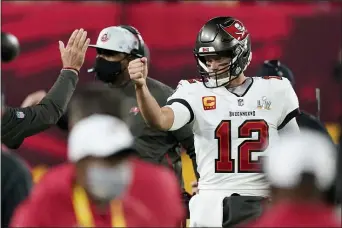  ?? ASHLEY LANDIS — THE ASSOCIATED PRESS ?? Tampa Bay Buccaneers quarterbac­k Tom Brady celebrates after his team scored a touchdown against the Kansas City Chiefs during the first half of Super Bowl 55on Sunday in Tampa.