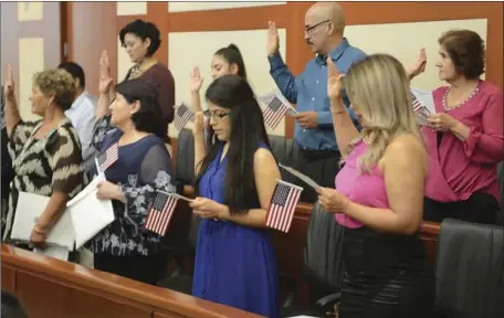  ?? ARTURO BOJORQUEZ PHOTO ?? A group of 19 former permanent residents from Venezuela, Philippine­s, Chile, Mexico and Pakistan became U.S. citizens Friday afternoon during a ceremony presided by U.S. Judge Magistrate Peter Lewis.