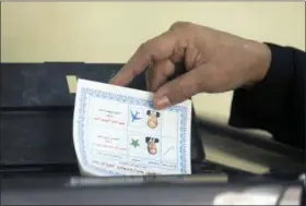  ?? AMR NABIL — THE ASSOCIATED PRESS ?? A woman casts her vote during the first day of the presidenti­al election at a polling station in Cairo, Egypt, Monday. Egyptians head to the polls on Monday but the presidenti­al election this time is not about who wins — that was settled long ago — but...