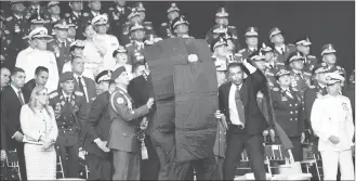  ?? AP PHOTO ?? Security personnel surround Venezuela’s President Nicolas Maduro during an incident as he was giving a speech in Caracas, Venezuela, on Saturday.