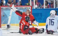  ?? JOEL MARKLUND/THE ASSOCIATED PRESS ?? The United States scores the game-winning goal past Canadian goaltender Dominic Larocque on Sunday at the Paralympic­s.