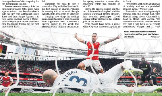  ?? Picture / AP ?? Theo Walcott kept the Gunners’ hopes alive with a goal just before the break.